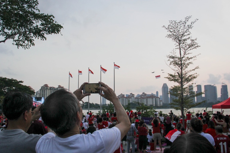 Visitors enjoying the live telecast of the National Day Parade along the