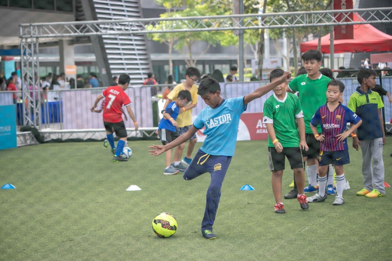 Children learning football techniques at the Experience Sports Football Clinic